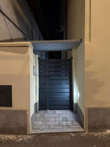 a blue garage door in a building with stairs at Les Maisons Manzoni in Magenta