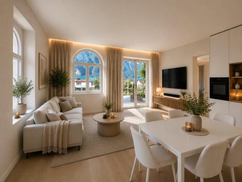 a living room with a white table and a couch at Lake House in Mühlehorn