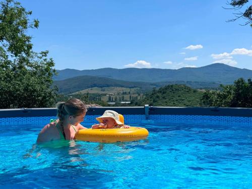 a woman and a child in a swimming pool at Csenger Vendégházak in Mátraverebély