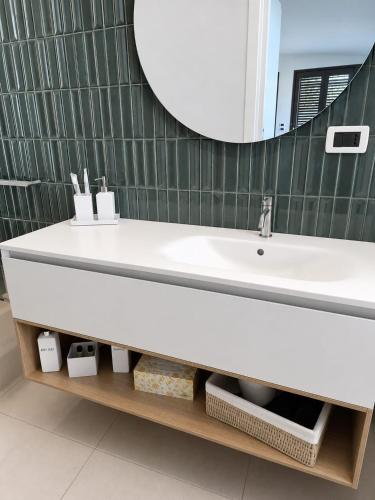a bathroom with a white sink and a mirror at Sarah apartment in Taormina