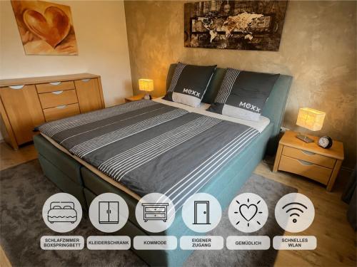 a bedroom with a large bed with various icons at Ferienwohnung Monika Ruhe & Natur nahe Bayreuth in Goldkronach