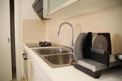 a small kitchen with a sink and a sink at Base Bridge Apartment - Zadar City Centre - Free parking in Zadar