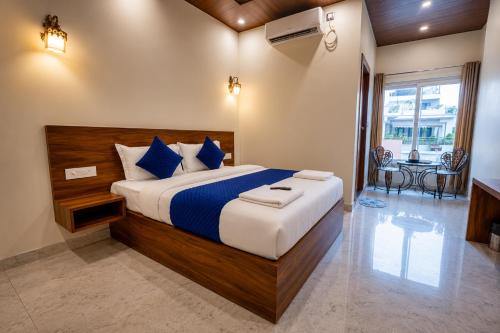 a bedroom with a large bed with blue pillows at Hotel Ganga MBS Rishikesh # Best location # Family Hotel in Rishīkesh