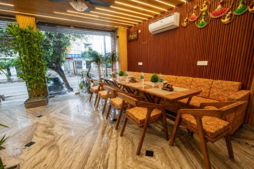a dining room with a long table and chairs at Hotel Ganga MBS Rishikesh # Best location # Family Hotel in Rishīkesh