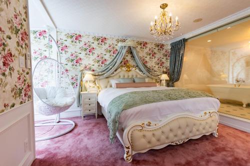 a bedroom with a bed and a tub and a chandelier at WhiteRunse in Takayama