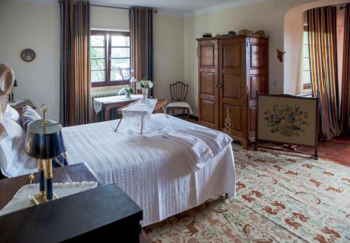 a bedroom with a white bed and a dresser at Quinta Santo António in Sintra