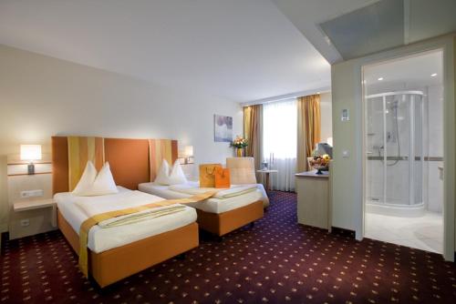 
Ein Bett oder Betten in einem Zimmer der Unterkunft City Hotel Isar-Residenz
