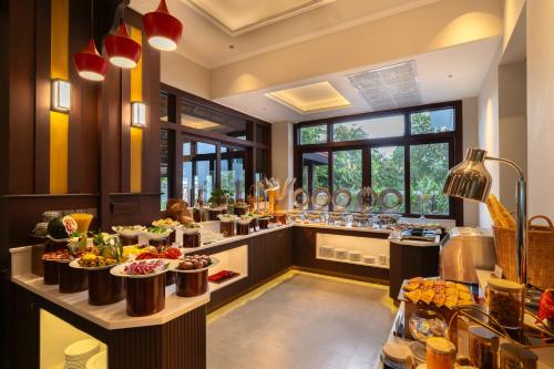 a buffet line in a restaurant with food at Royal Riverside Hoi An Hotel-Newly Renovated & Reopened in Hoi An