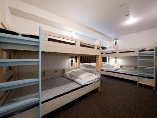 a room with two bunk beds in a room at Guesthouse Sign in Kyoto