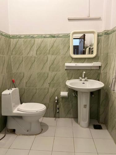 a bathroom with a toilet and a sink at Sky view Resort Shogran in Shongran