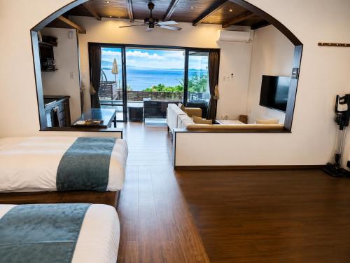 a hotel room with two beds and a large mirror at 風の音 in Motobu