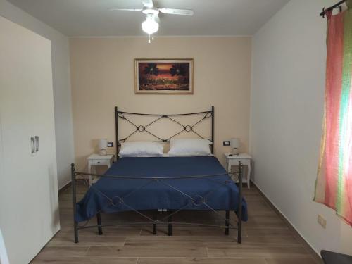 a bedroom with a bed with a blue blanket at Penthouse a Silvi Marina in San Silvestro