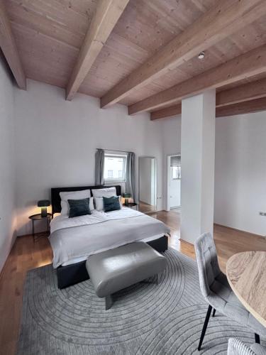 a bedroom with a large bed and a wooden ceiling at PaderCityLoft Apartment Pfau in Paderborn