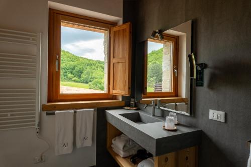 a bathroom with a sink and a window at Aura Relais in Urbino