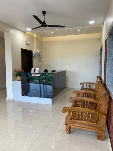a waiting room with chairs and a reception desk at Anandi Hotel Guhagar in Guhagar