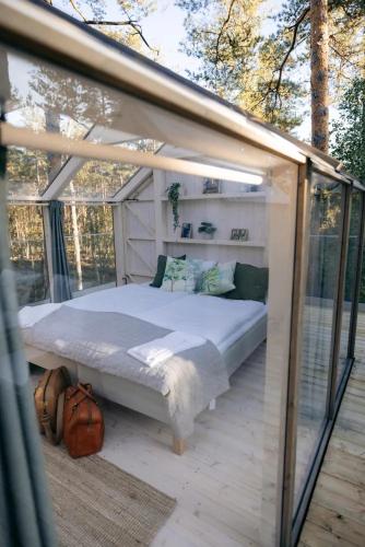 a bedroom with a bed inside of a greenhouse at Kosta Lodge in Kosta