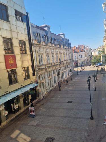 an empty city street with buildings and street lights at Elena Apartments in Absolute Center in Ruse
