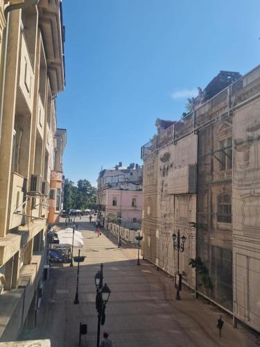 an empty city street with buildings and street lights at Elena Apartments in Absolute Center in Ruse