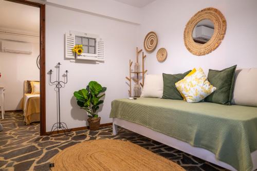a bedroom with a bed and a mirror at Agnanti Seaview Villa in Karlovasi