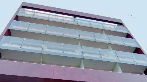 a building with blue balconies on the side of it at SAZ City Life Boutique Hotel in Ioannina