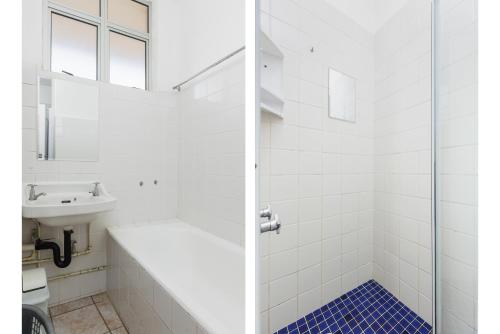 a white bathroom with a sink and a shower at Peacehaven 108 in Scottburgh