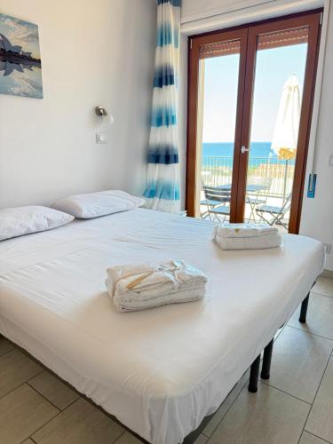 a bedroom with a bed with a view of the ocean at Supramonte Guesthouse in Agropoli