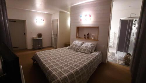 a bedroom with a bed and two pillows on it at La Maison d'eglantine in Marnaves