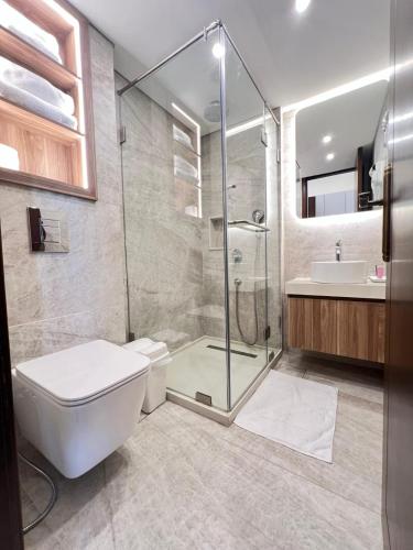 a bathroom with a shower and a toilet and a sink at Batroun boutique suites in Batroûn