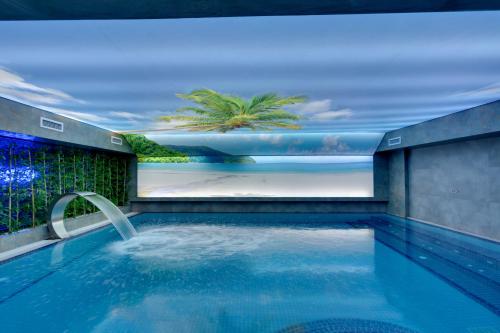 a swimming pool with a painting of a palm tree at Grande Arte Hotel in Eskisehir