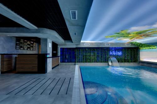 a large swimming pool in a building with a ceiling at Grande Arte Hotel in Eskisehir