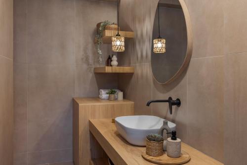 a bathroom with a sink and a mirror at Don Gerassimo in Argostoli