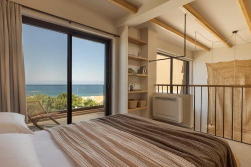 a bedroom with a bed and a large window at Don Gerassimo in Argostoli