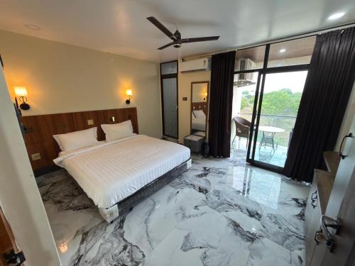 a bedroom with a marble floor with a bed at PARK CITY HOTEL & Resort in Gangāyapalle