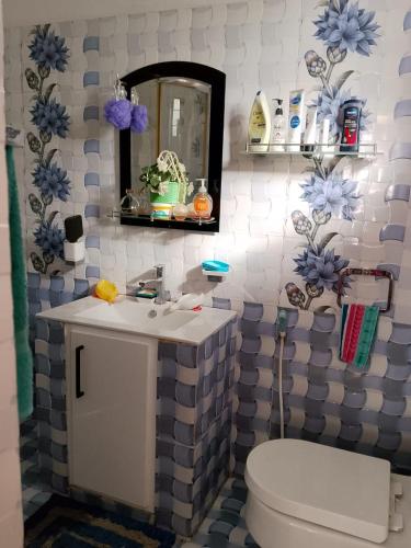 a bathroom with a toilet and a sink and a mirror at Ciao Villa, Kandy in Kandy