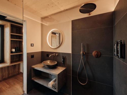 a bathroom with a shower and a sink at Anima-Suites adults only in Terlano