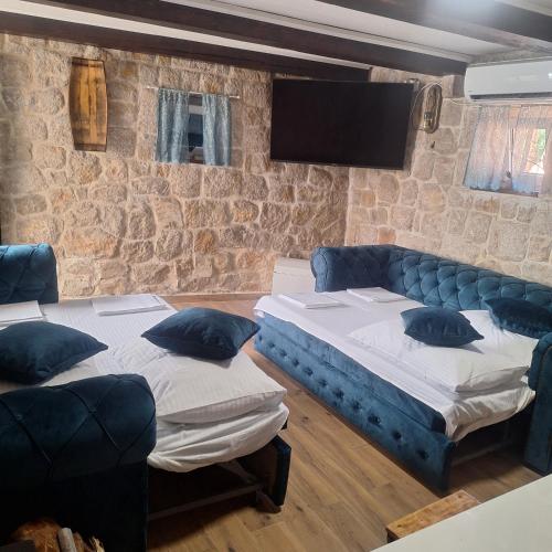 a living room with two beds and a couch at Villa Sound of Silence in Poljica Kozička