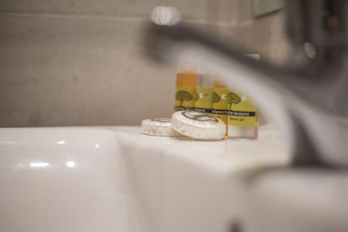 a toothbrush sitting on top of a sink at Museum Hotel, a member of Brown Hotels in Athens