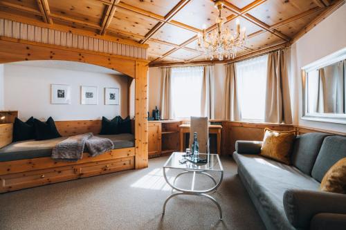 a living room with a couch and a table at Hotel Bergwelt in Obergurgl