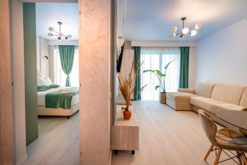 a living room with a bed and a living room with a couch at Blue Boat Aparthotel in Mamaia Sat/Năvodari
