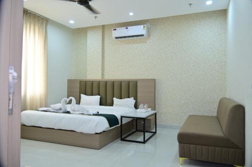 a hotel room with a bed and a chair at Hotel B R Residency in Bikaner