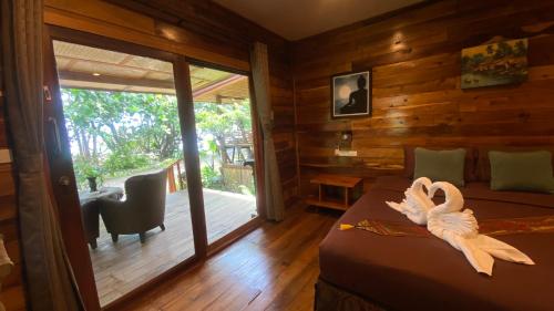 a bedroom with a bed with a swan decoration at Coconut Lanta Resort @Klong Dow beach in Ko Lanta