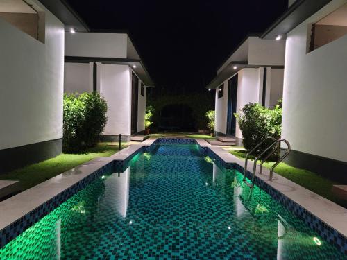 a swimming pool at night in a villa at Geza Breeze Residence in Dar es Salaam