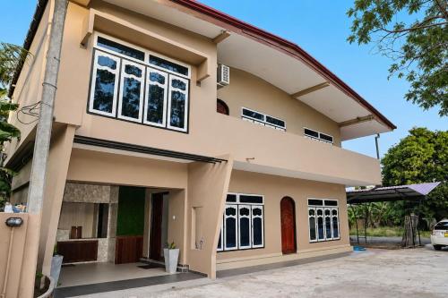 a house with a large window at Oasis Guest House in Jaffna