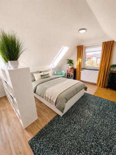 a bedroom with a large bed and a rug at Modern apartment with balcony & panoramic view in Tirschenreuth
