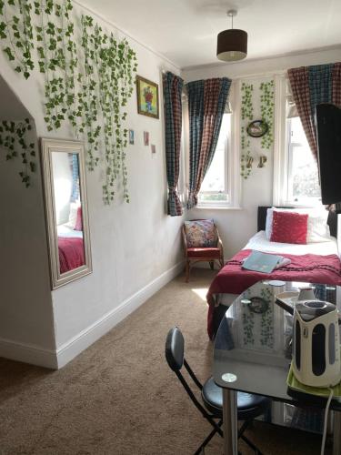 a bedroom with a bed and a glass table at The Palms Guest house in Torquay