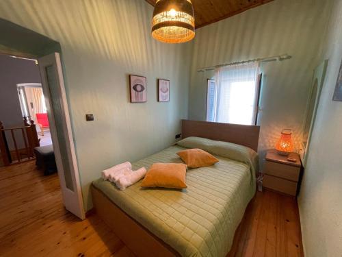 a bedroom with a bed with two pillows on it at The Great Balcony in Ioulis