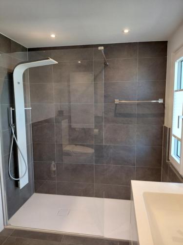 a shower with a glass door in a bathroom at Berner Hostel in Bern