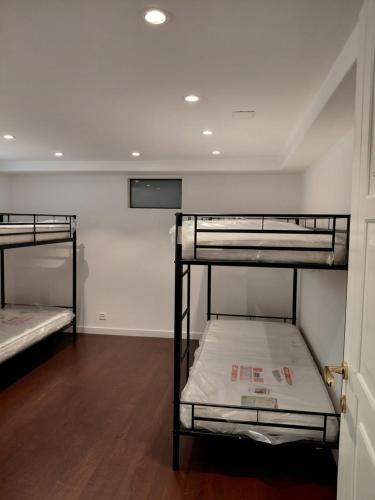 a room with two bunk beds and a door at Berner Hostel in Bern