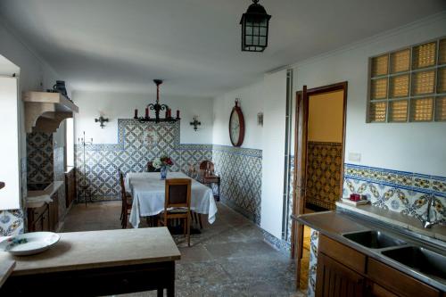 a kitchen with a table and a dining room at Quinta Santo António in Sintra