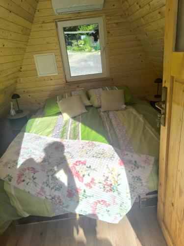 a bedroom with a bed in a wooden cabin at Hiška Timi in Malečnik